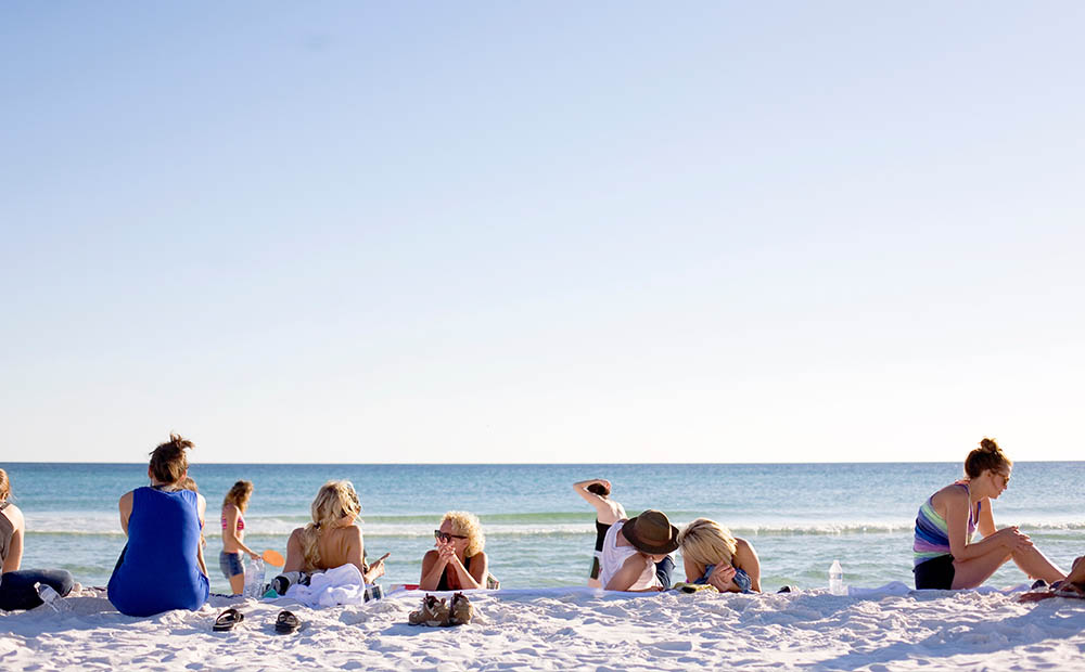 women on beach via unsplash